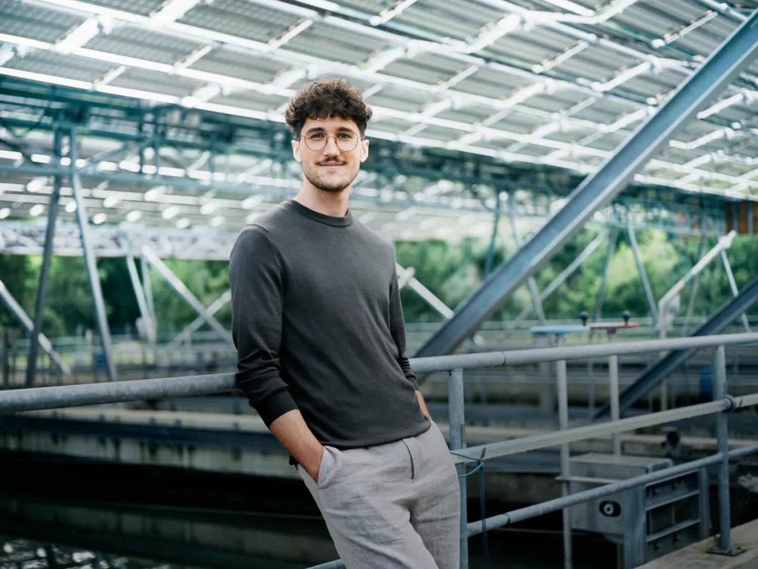 Student standing in greenhouse